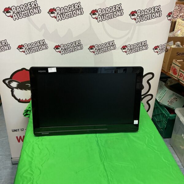 Front view of a Sharp Aquos LCD television with remote.