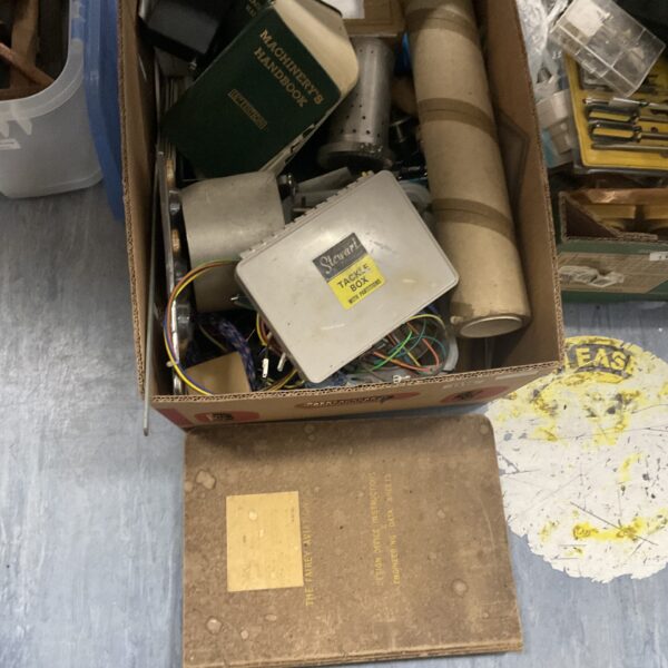 Shed clearance lot with machinery handbook and tackle box visible.