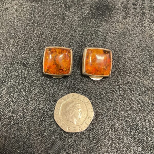 Vintage silver clip on earrings with amber stones.