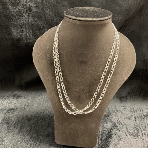Two delicate 925 silver chain necklaces displayed on a mannequin.
