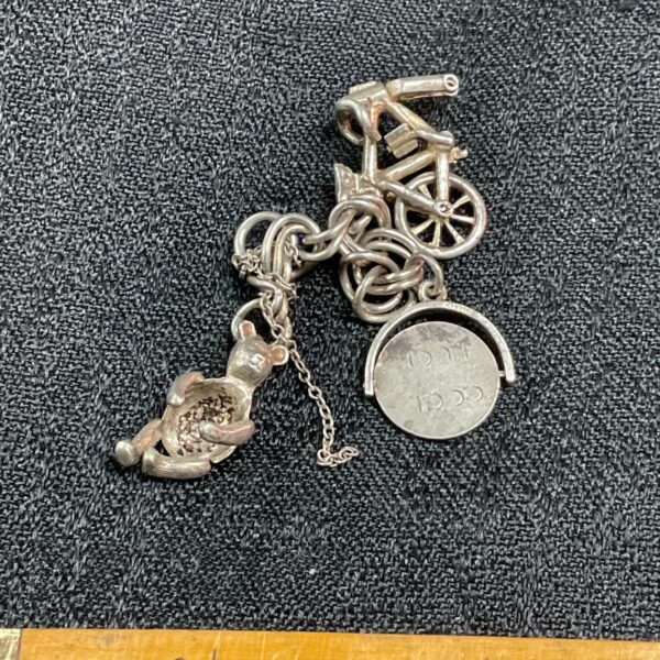 Vintage silver charm bracelet with rocking horse charm.