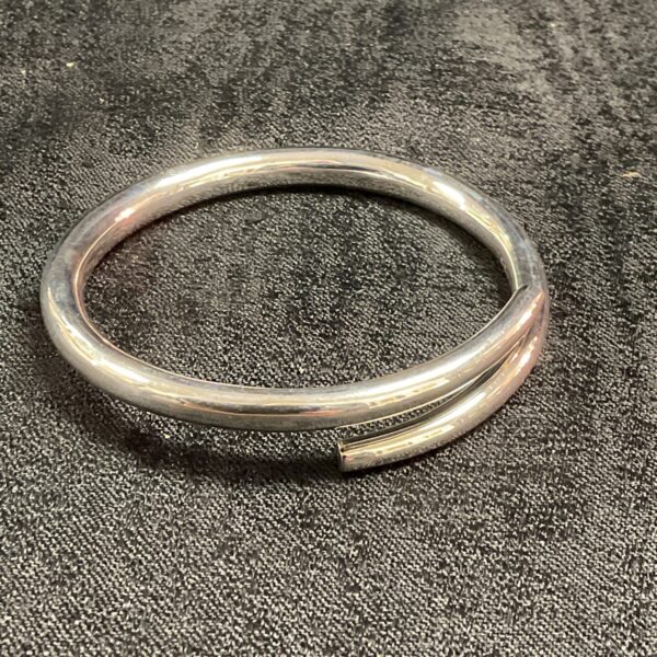Sleek silver coil bracelet, minimalist jewellery design.