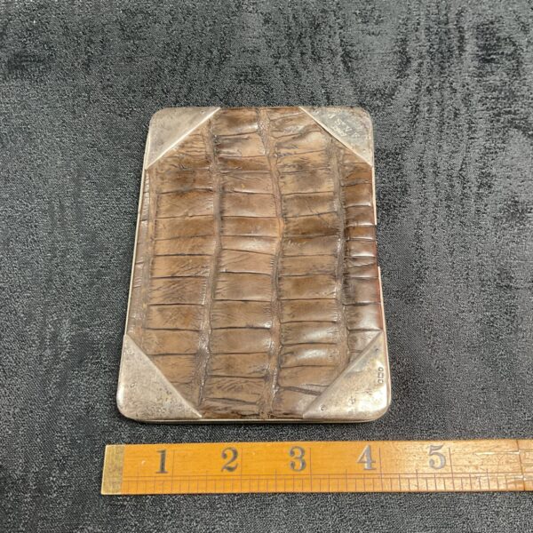 Antique 1909 silver and crocodile wallet, detailed front view.