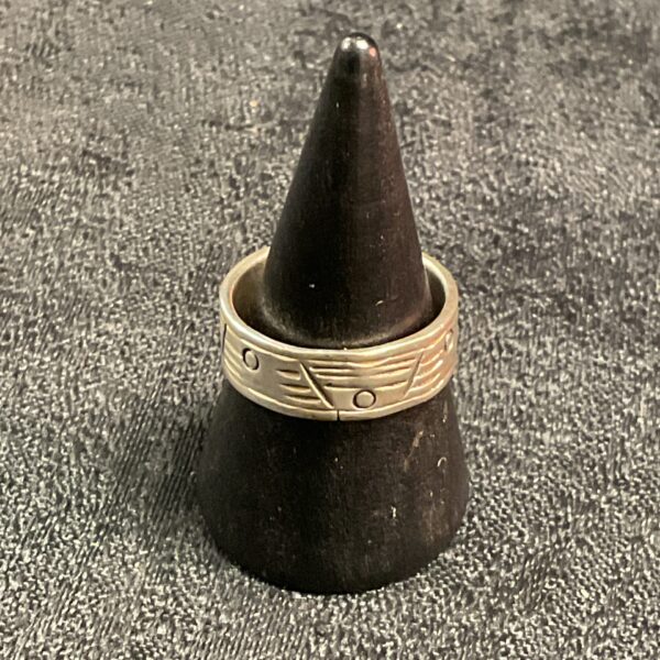Silver geometric ring size O on display.