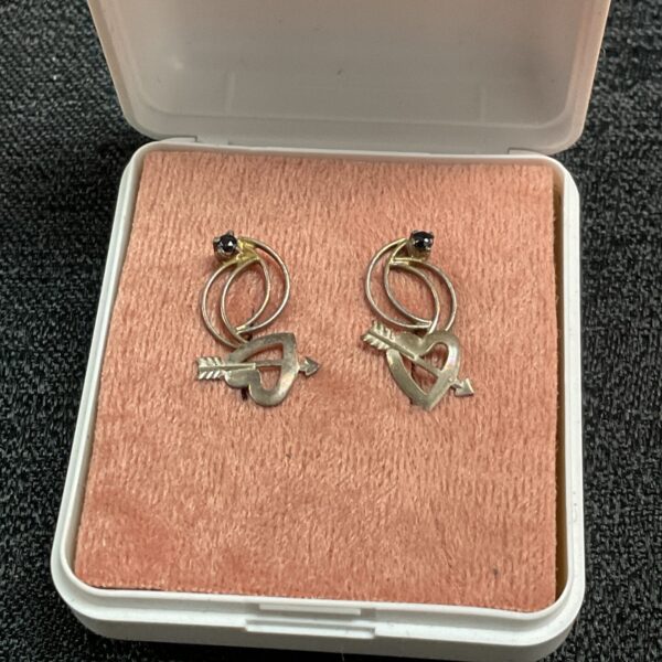 Vintage silver hoop earrings presented in a box.