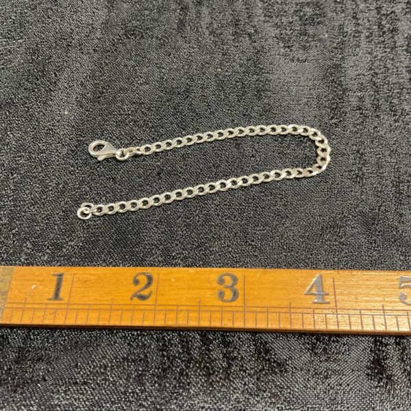 Close-up of a vintage silver Kebrblink chain bracelet.