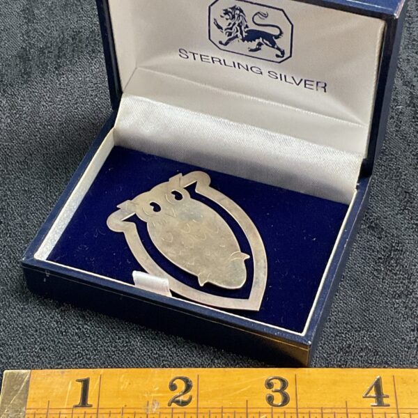 Detailed hallmarked silver owl page marker for books.