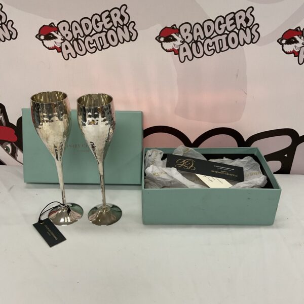Pair of elegant silver-plated champagne flutes on display.