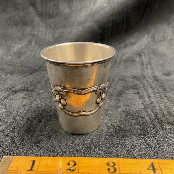 Vintage silver test kitchen cup with floral embossing.