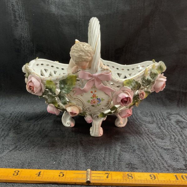 Antique Sitzendorf porcelain basket with cherub and floral details.
