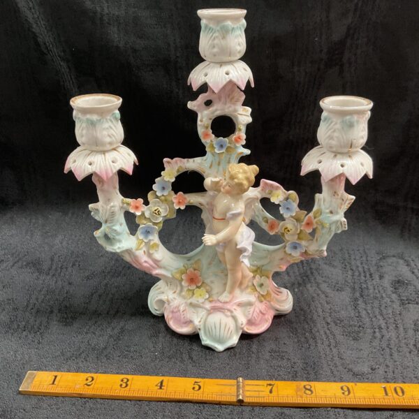 Antique Sitzendorf porcelain candelabra with cherub and floral details.