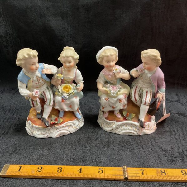 Antique Sitzendorf porcelain figures of a boy and girl.
