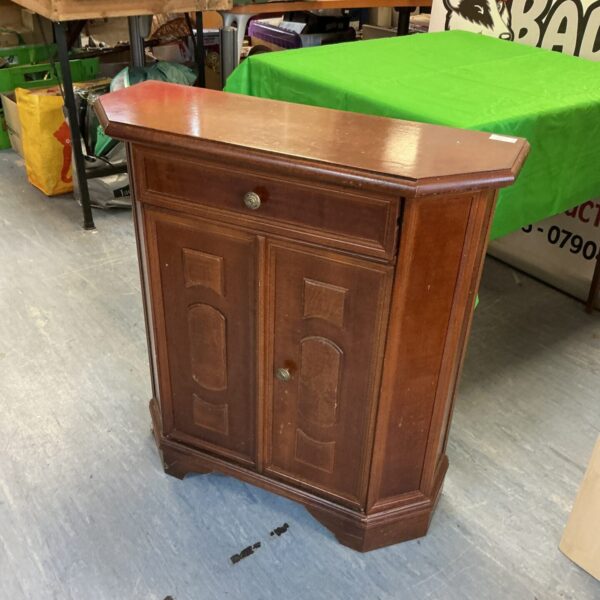 Small mahogany cabinet with a single door, vintage storage solution.