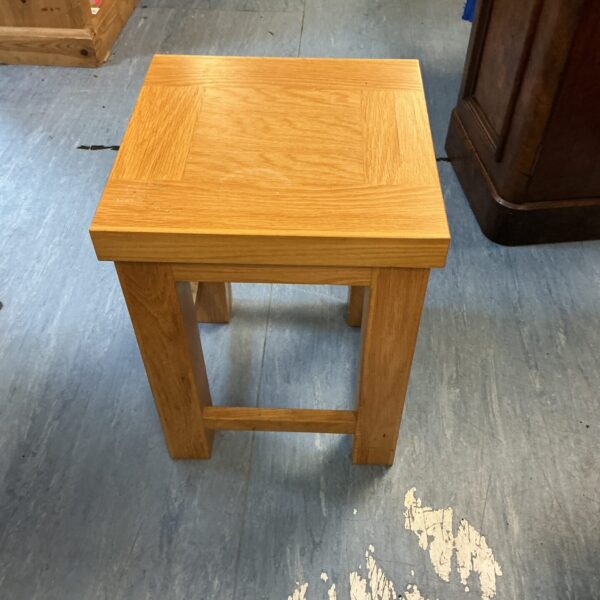 Small oak table with visible wood grain, side view.
