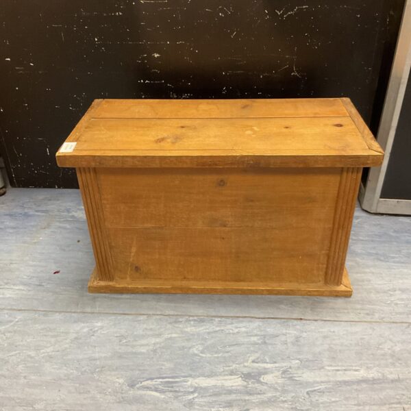 Vintage small pine storage trunk for linens and keepsakes.