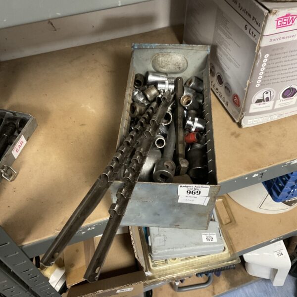 Vintage socket set with metal storage rails for workshop tools.