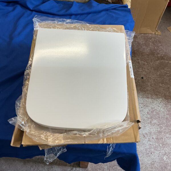 Lot of four new soft close toilet seats for bathroom use.