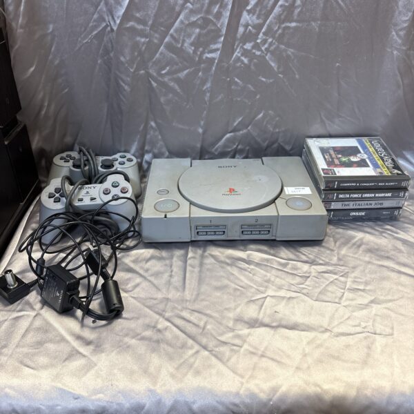 Sony PlayStation 1 console with games and controllers.