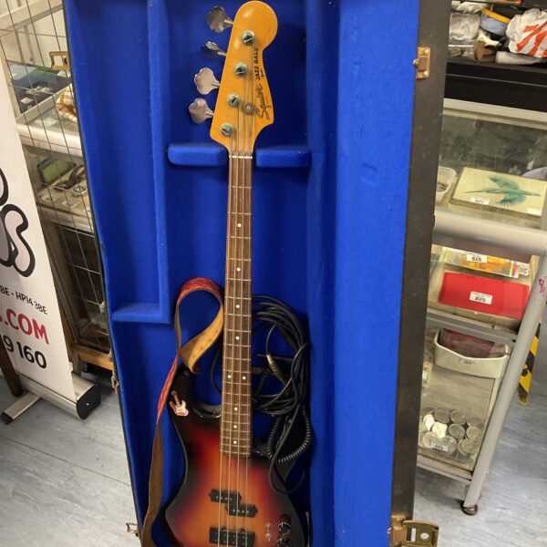 Squire Jazz Bass guitar in a blue wooden case.