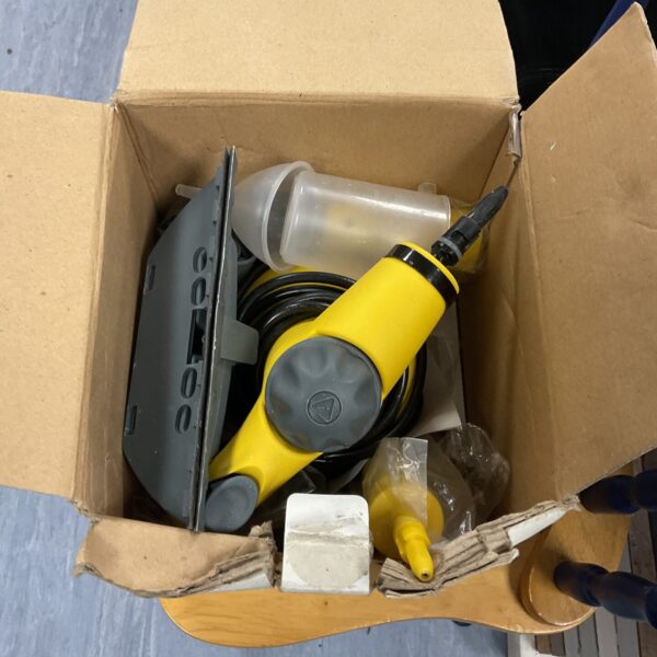 Yellow handheld steam cleaning machine presented for auction.