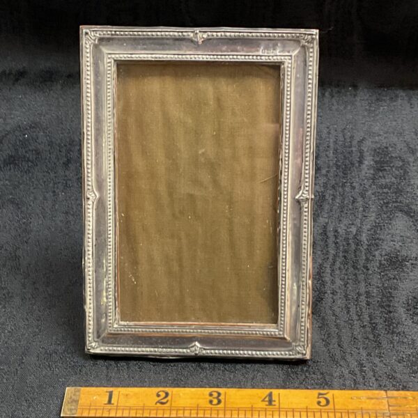 Antique sterling silver photo frame with hallmarked silver detail.