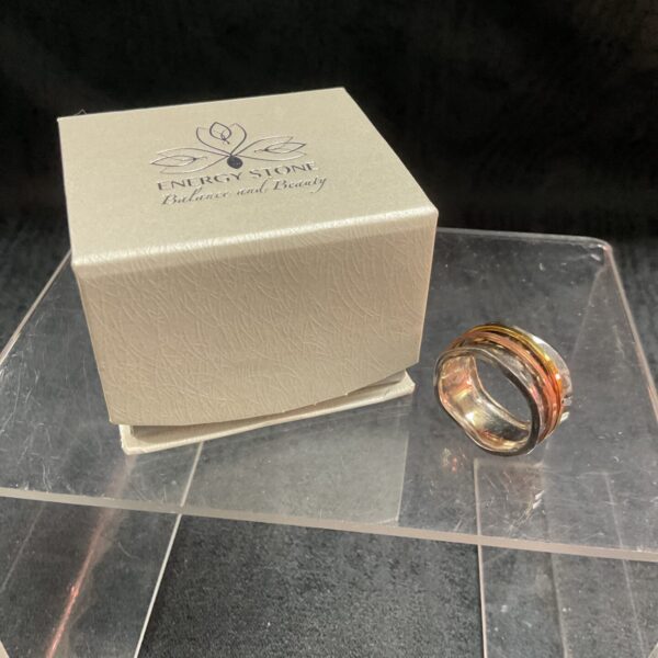 Close-up of sterling silver spinner ring with copper bands.