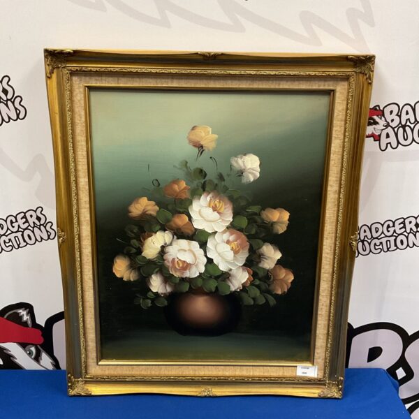 Vintage still life oil painting of roses in a gilt frame.