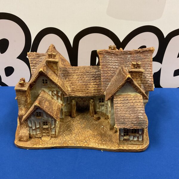 Vintage Stubbs Suffolk cottage with thatched roof and detailed walls.