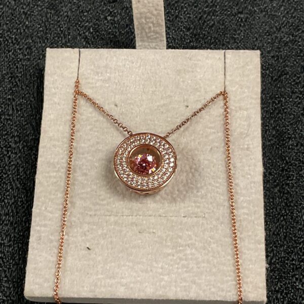 Close-up of a Swarovski shimmerstone pendant necklace with gilt details.