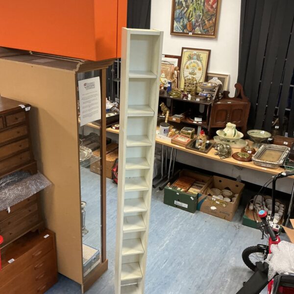 Tall white CD storage unit for media organisation.