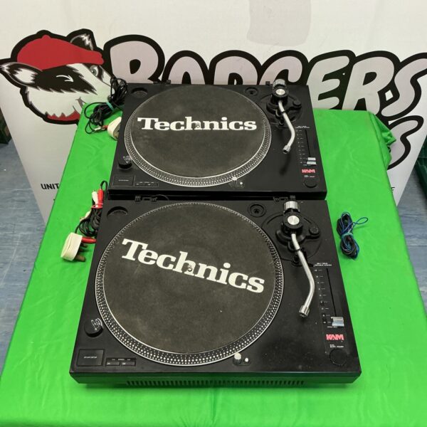 Pair of vintage Technics turntables with slip mats.