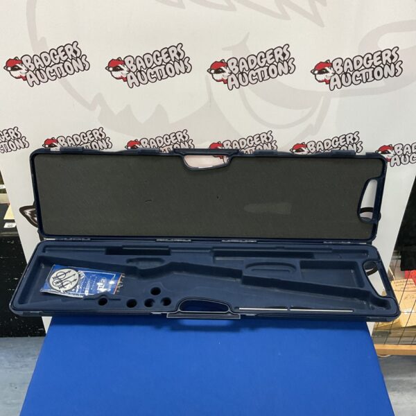 Open Teknys rifle case on a blue backdrop, showing padded interior.