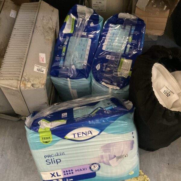 Sealed packs of Tena Pro Skin briefs in size XL for incontinence protection.