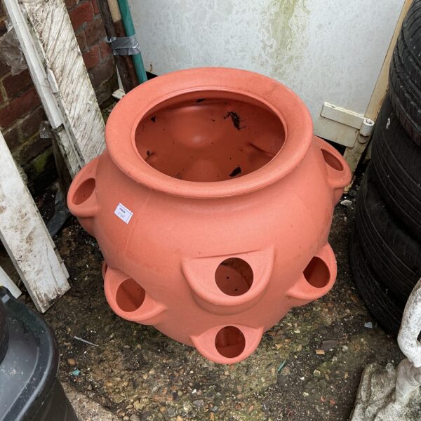 Terracotta strawberry planter for growing plants outdoors.