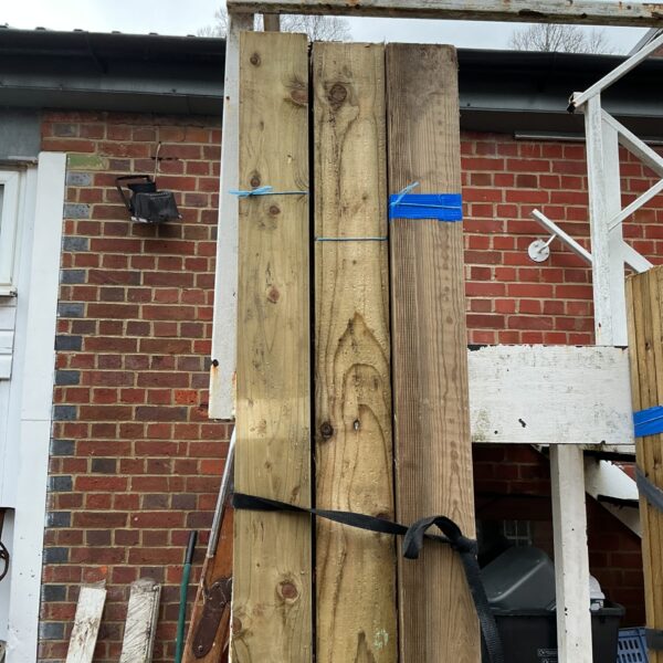 Three bundles of 8ft timber stacked outdoors, ready for projects.