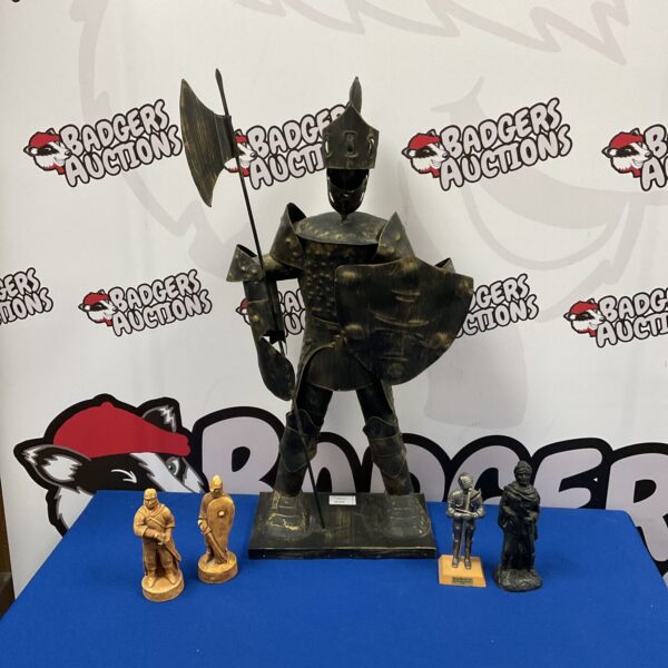 Large tin knight sculpture with four historical figures on display.