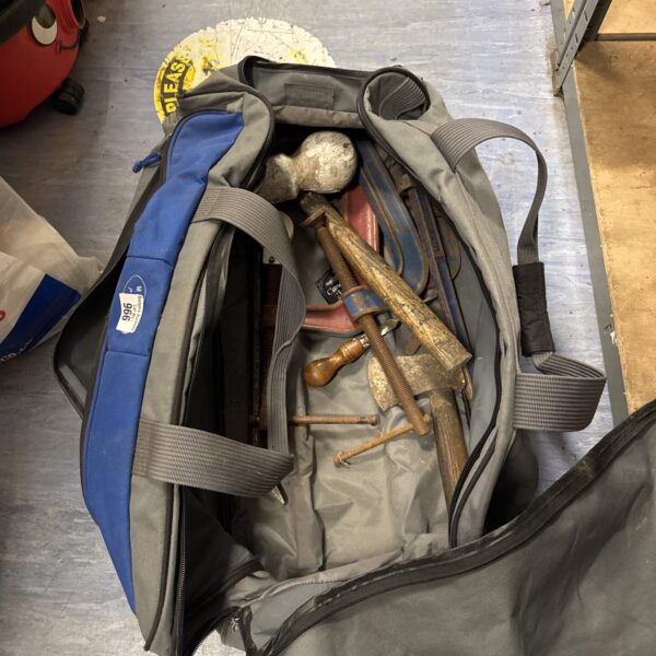 Blue tool bag filled with various tools, including G clamps and grips.