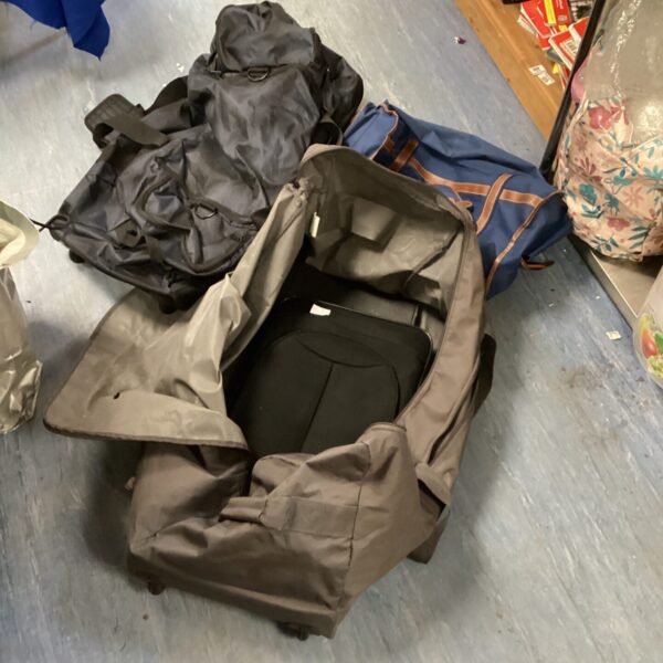 Vintage travel bag lot featuring Holle style bags and a wheeled suitcase.