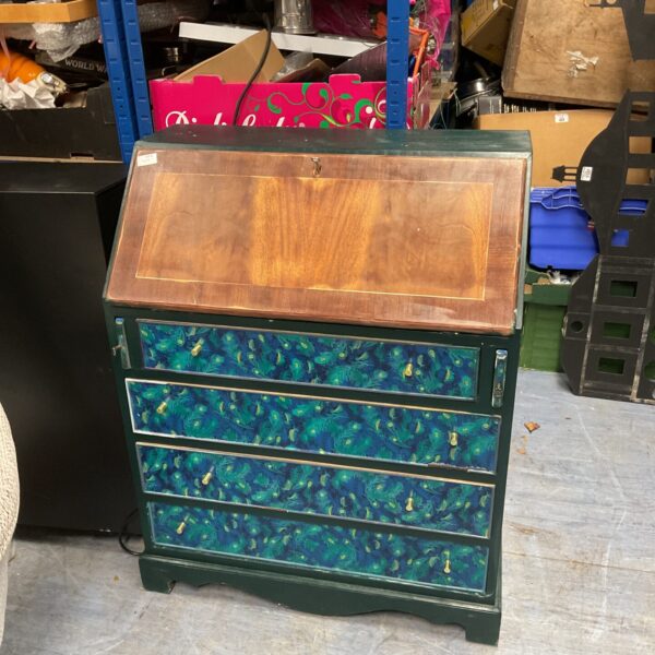 Vibrant upcycled writing bureau with peacock pattern.