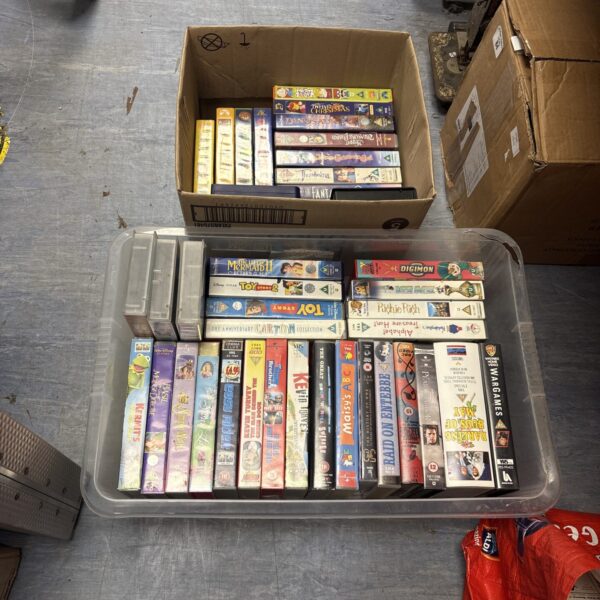 Vintage VHS movie tape collection including Disney and Warner Bros titles.