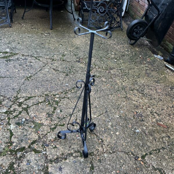 Vintage Victorian metal plant stand for garden display.