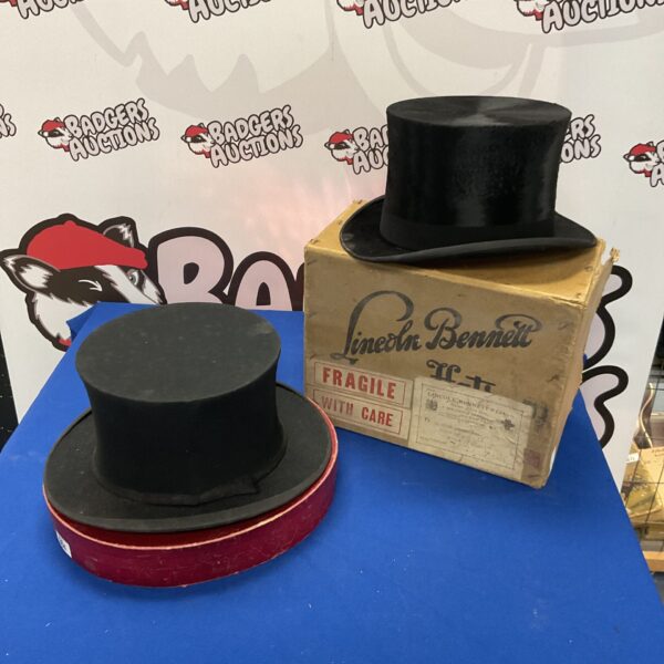 Group of two Victorian top hats on display.