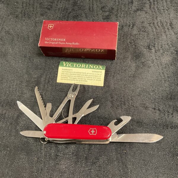 New Victorinox Swiss Army knife with red handle in box.