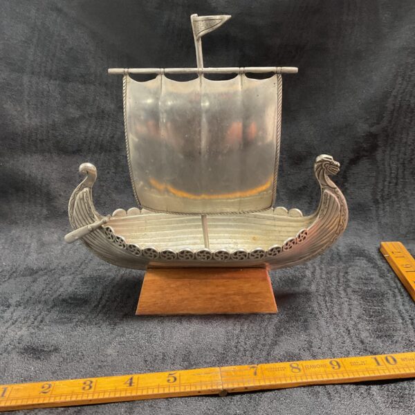 Detailed aluminium Viking ship model for nautical decor.
