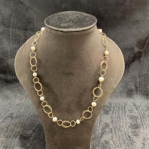 Vintage 12k gold filled necklace with beads on a neutral background.