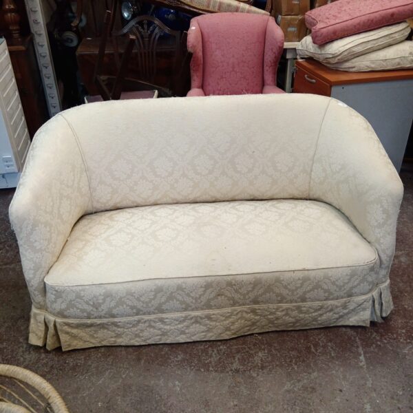 Patterned vintage 2-seater sofa in a room setting.