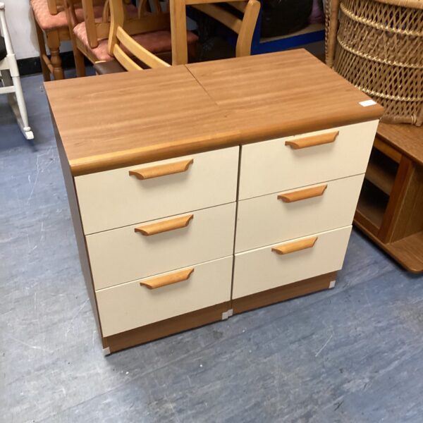Vintage walnut veneer bedside cabinets with three drawers.