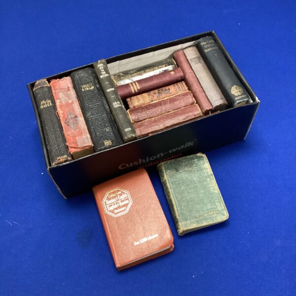 Stack of vintage Bibles and religious books, antique collection.
