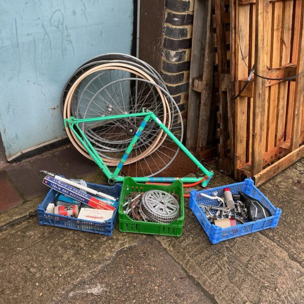 Vintage bicycle spares job lot with green frame.