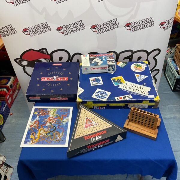 Vintage board games lot including Monopoly, Crossword, Triominos and Capital Adventure.